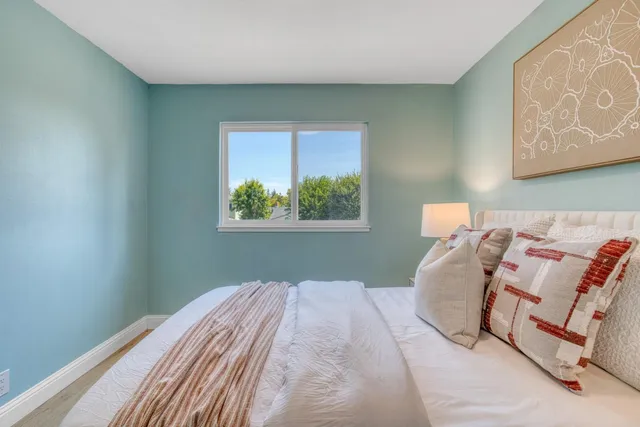 a bedroom with bed and a window