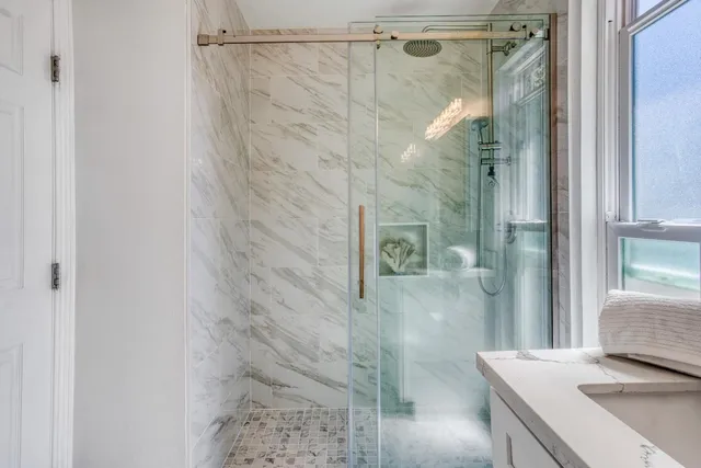 a bathroom with a shower and a sink