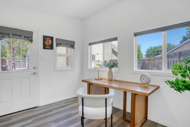 a view of a room that has a table and chair in it