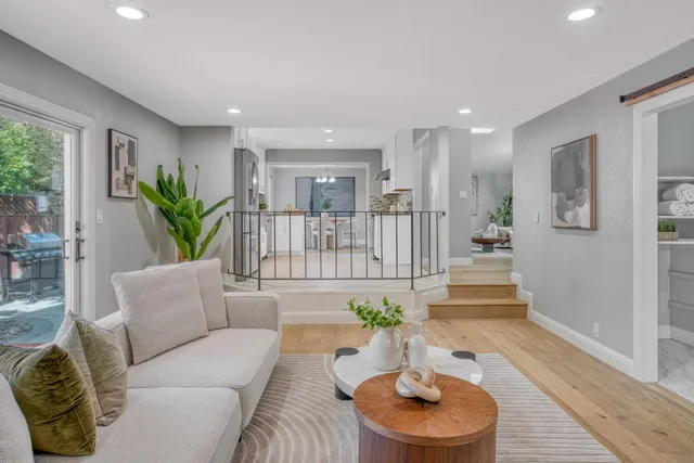 a living room with furniture and wooden floor