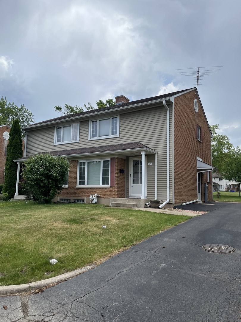 31 Krotiak Road Park Forest, IL 60466 - Photo 2 of 15 a front view of a house with a garden and yard