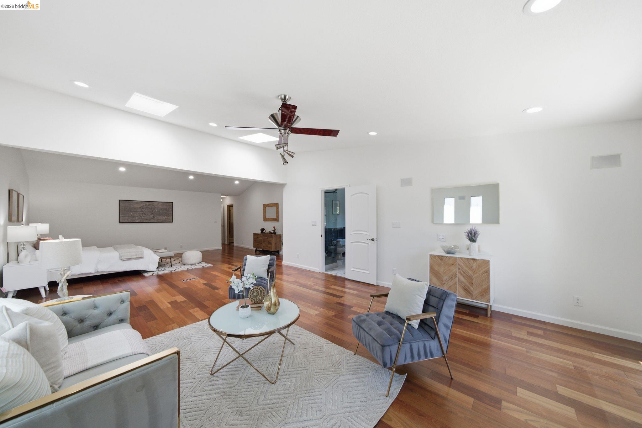 11133 Golf Links Road Oakland, CA 94605 - Photo 28 of 57 Spacious room featuring wood-finish flooring and a vaulted ceiling with skylights