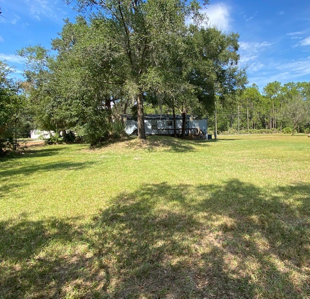 96142 Lang Road Yulee, FL 32097 - Photo 12 of 15 a view of a swimming pool with an outdoor seating