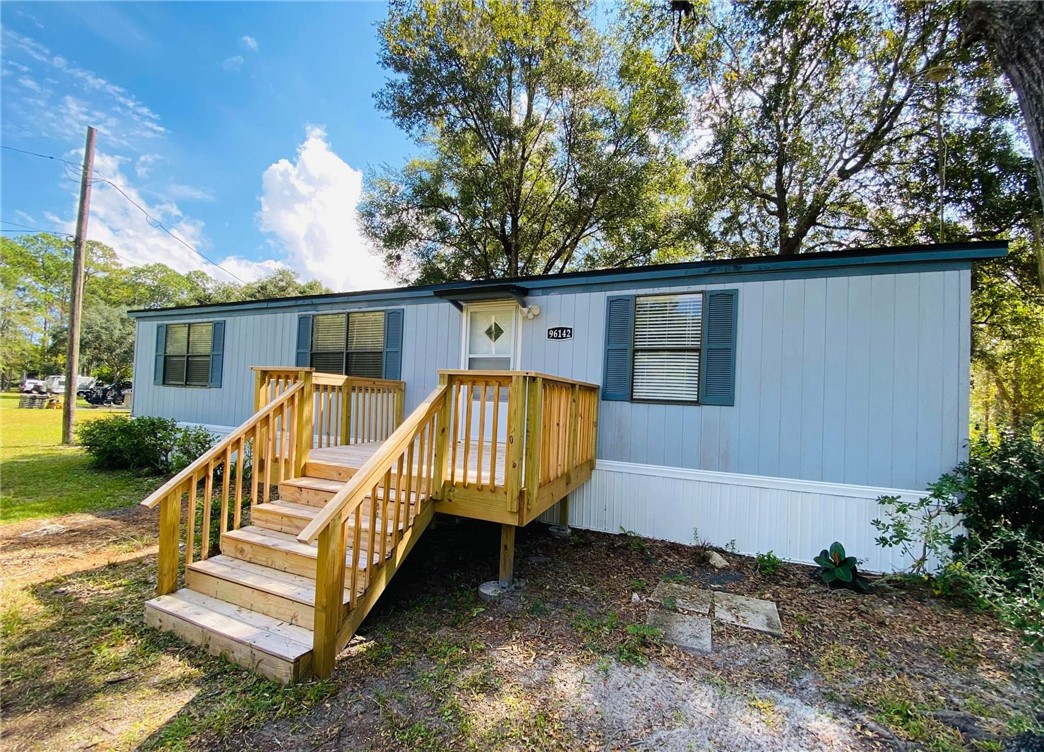 96142 Lang Road Yulee, FL 32097 - Photo 2 of 15 a view of a house with backyard and sitting area