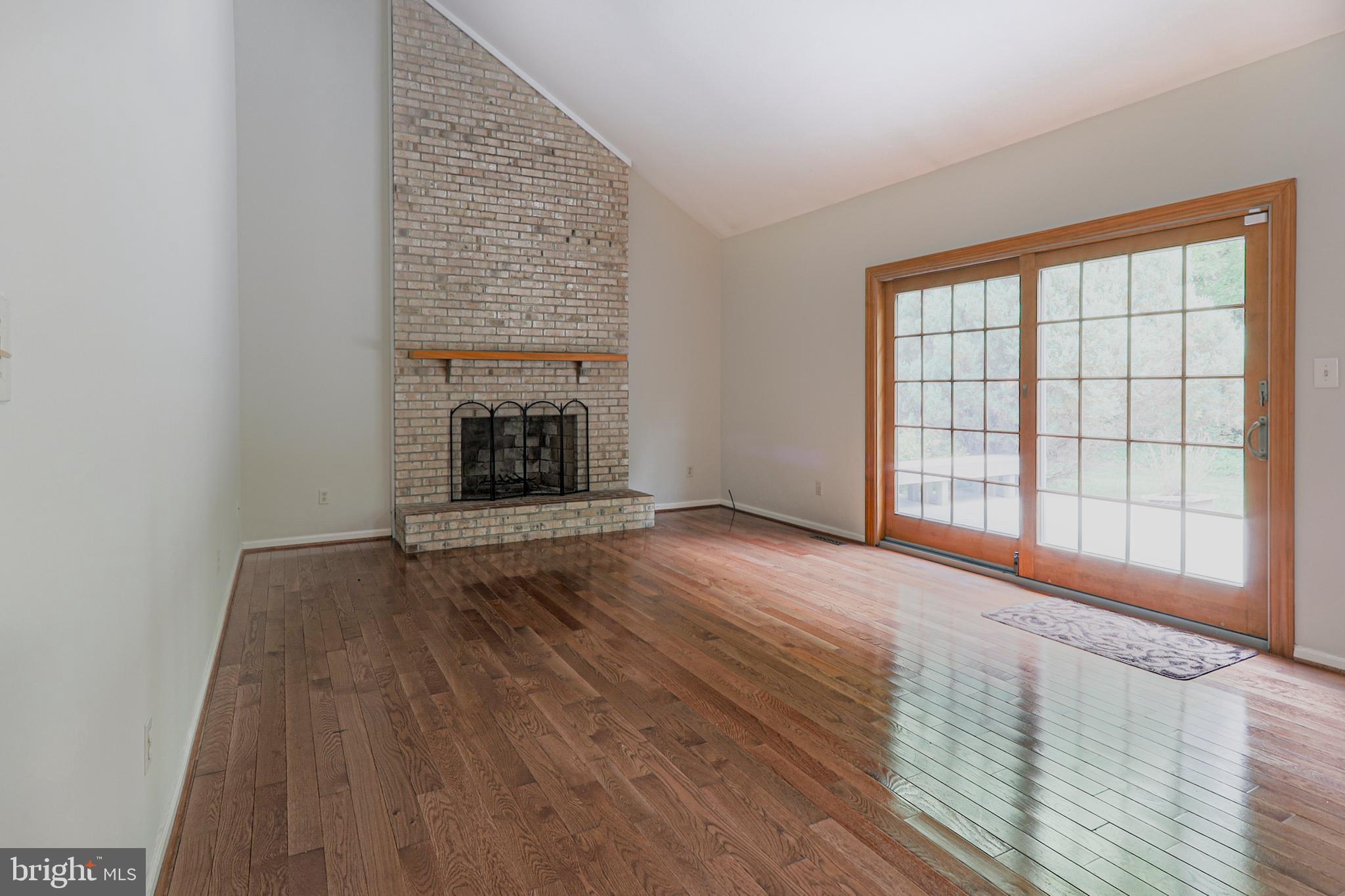 138 Woodland Road Newark, DE 19702 - Photo 11 of 29 Family room with vaulted ceiling, brick fireplace