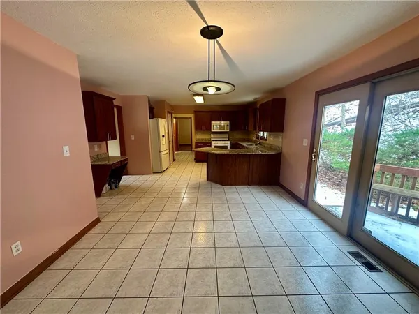 a view of a dining room with furniture wooden floor and chandelier