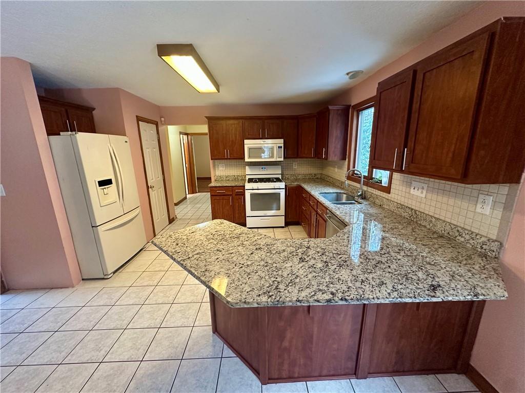 513 Sandra Lane Cheswick, PA 15024 - Photo 14 of 49 a kitchen with stainless steel appliances granite countertop a stove a sink and a microwave