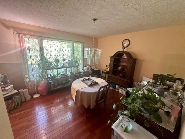 a bedroom with bed and wooden floor