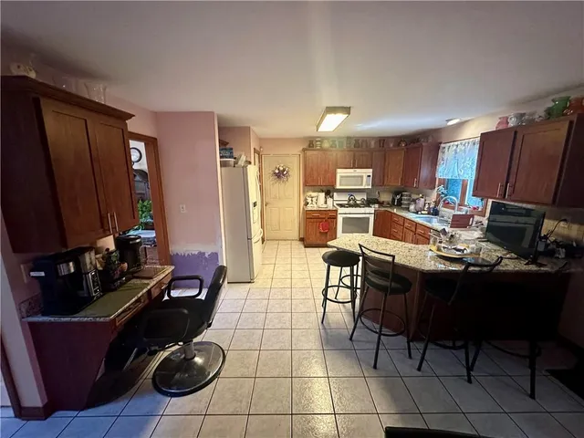 a living room with furniture a dining table and chairs