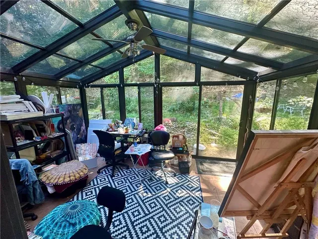 a living room with furniture and a floor to ceiling window
