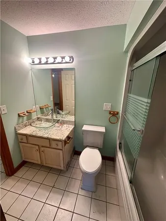 a bathroom with a sink a toilet and mirror