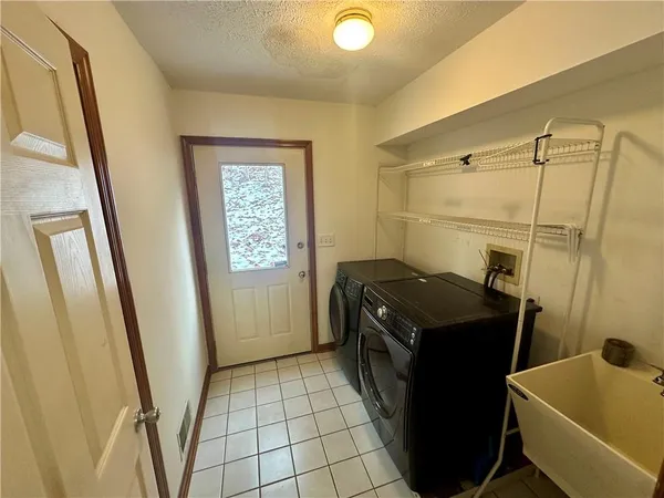 a utility room with a sink a washer and dryer