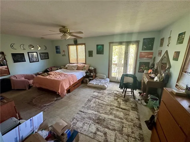 a bedroom with bed and a window