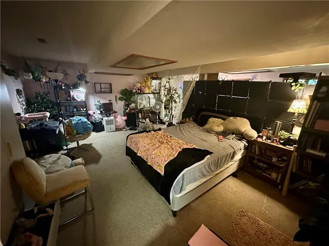 a living room with furniture a flat screen tv and a window