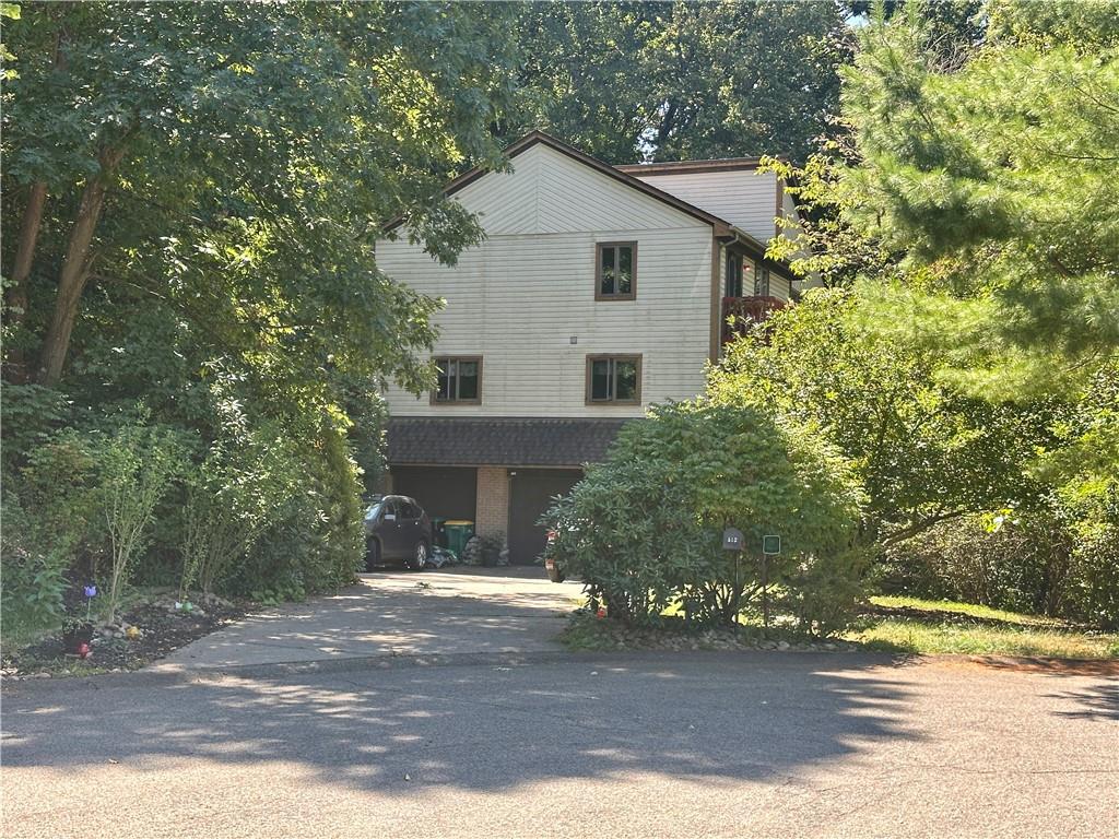 513 Sandra Lane Cheswick, PA 15024 - Photo 4 of 48 a front view of a house with a yard and garage