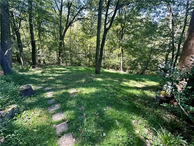 a view of a chair and table in the backyard of a house