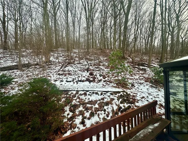 a view of a garden with wooden fence