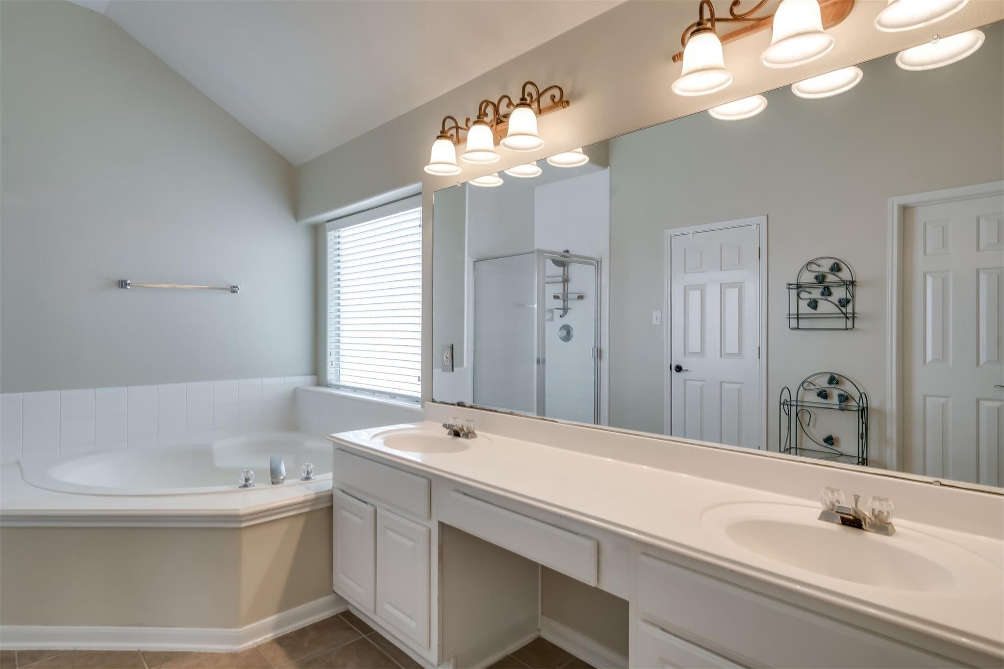 3419 La Fleur Lane Spring, TX 77388 - Photo 16 of 26 a bathroom with a tub a sink and mirror