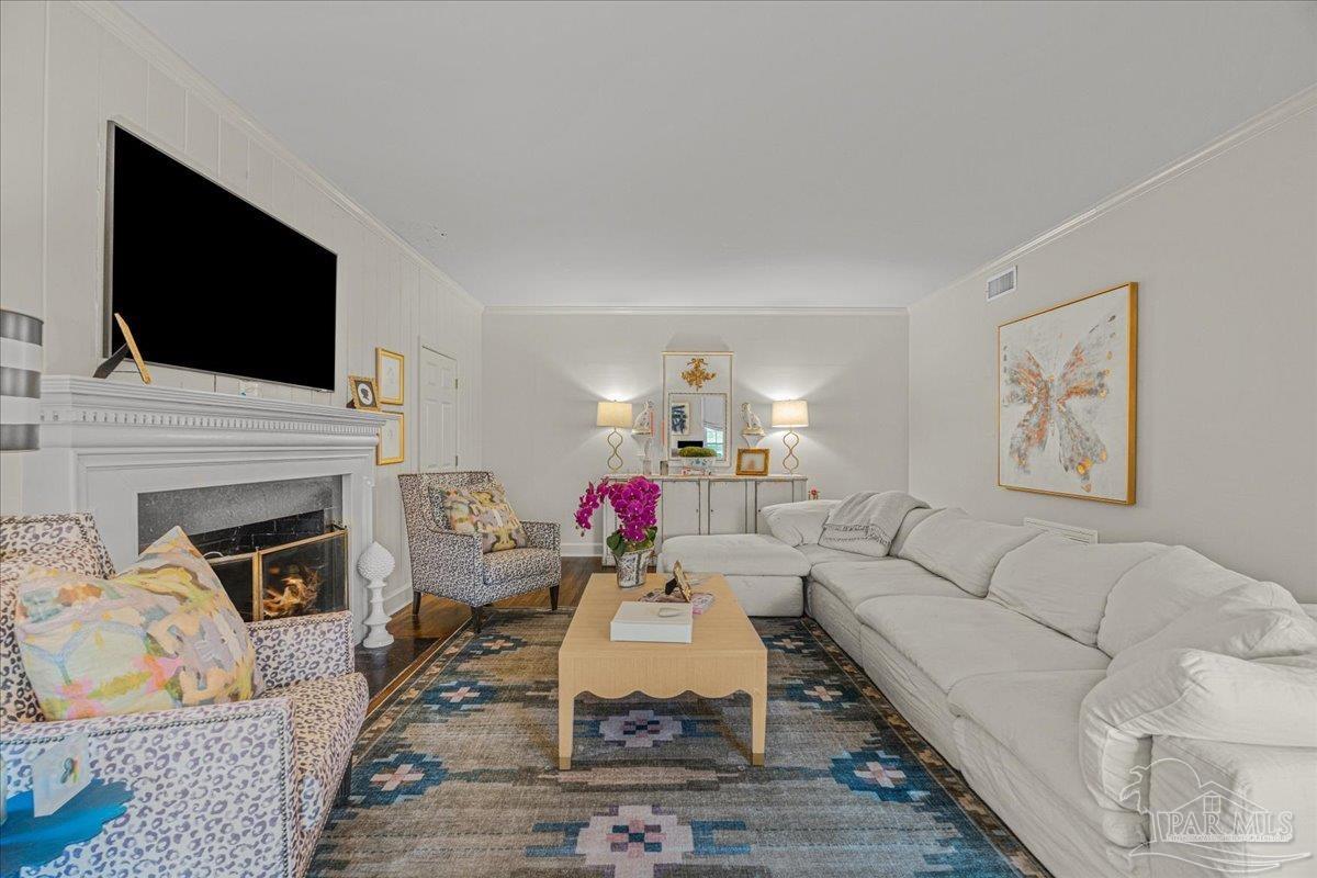 3361 Palermo Road Pensacola, FL 32503 - Photo 22 of 50 a living room with furniture a flat screen tv and a fireplace