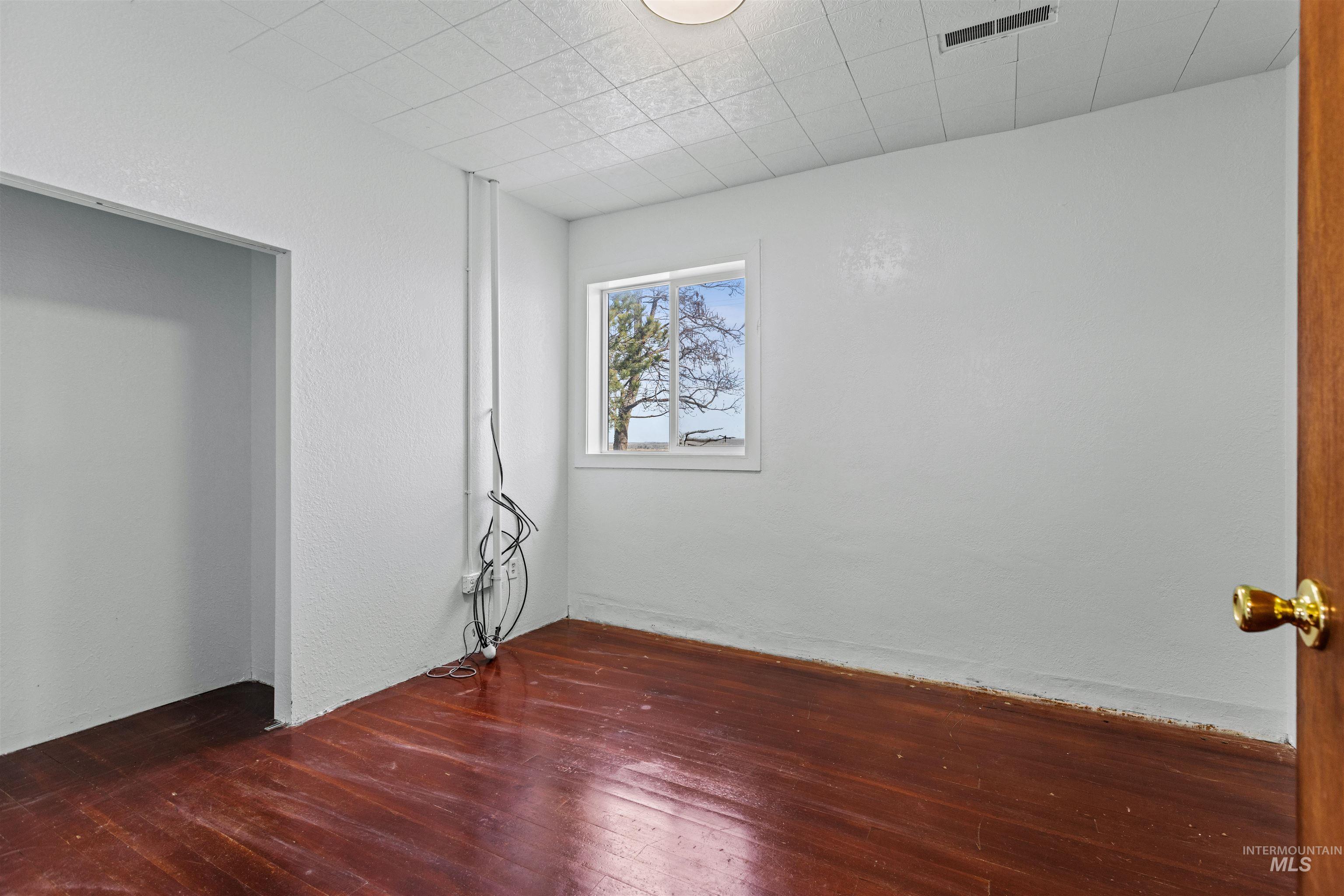 5168 South Jump Creek Road Marsing, ID 83639 - Photo 22 of 40 Unfurnished room with hardwood / wood-style floors and a textured wall