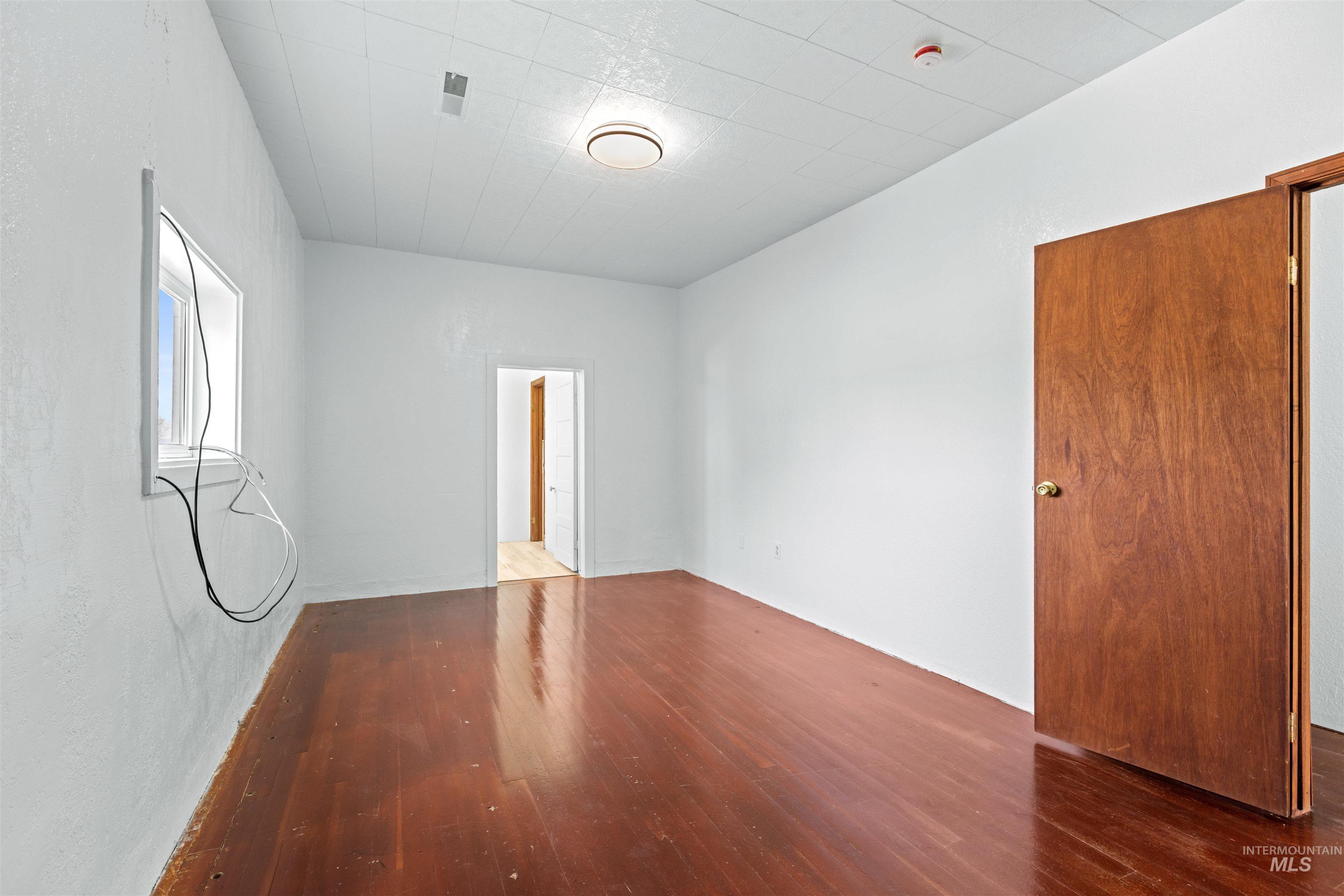 5168 South Jump Creek Road Marsing, ID 83639 - Photo 24 of 40 Unfurnished bedroom with dark wood-type flooring