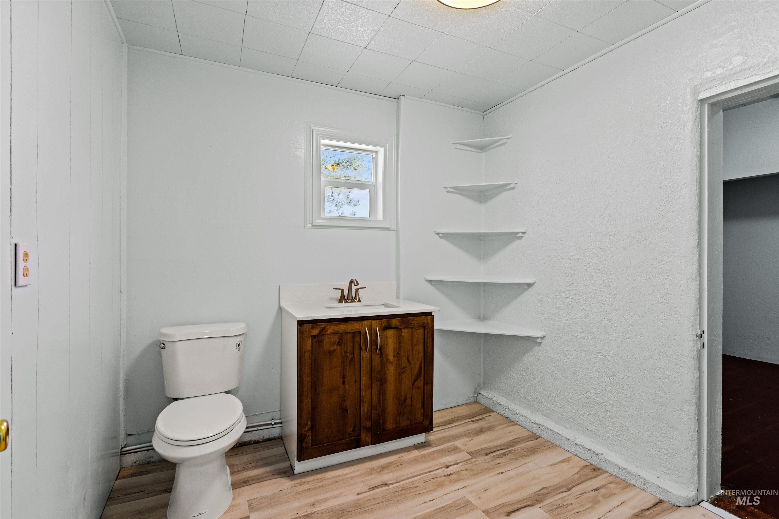 5168 South Jump Creek Road Marsing, ID 83639 - Photo 31 of 40 Bathroom featuring light wood finished floors, vanity, and a textured wall