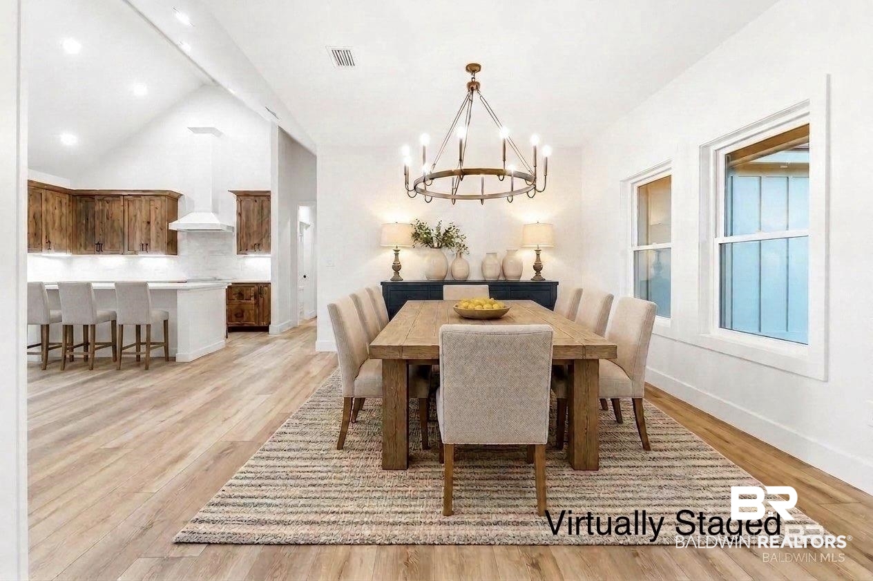 28310 Comstock Road Elberta, AL 36530 - Photo 5 of 60 Virtually Staged - Open concept living area featuring a vaulted ceiling and wood-finish flooring