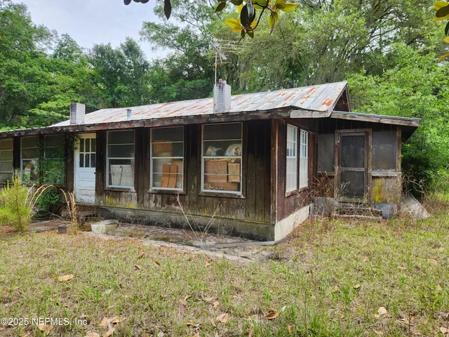 a backyard of a house with yard and outdoor seating