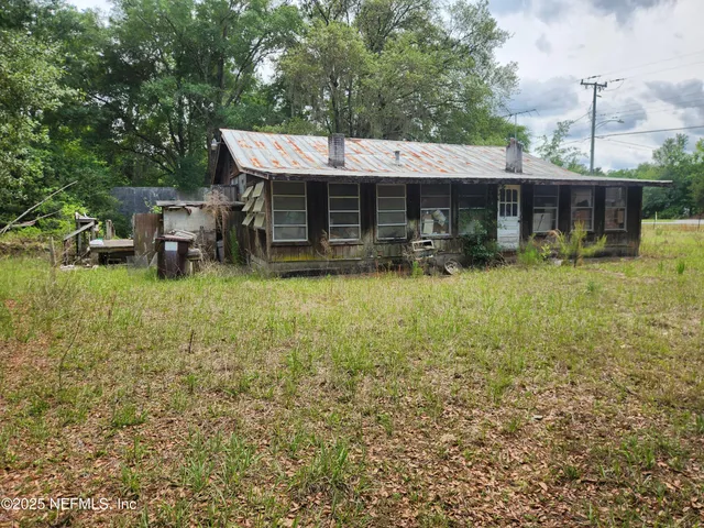 a backyard of a house with yard and outdoor seating