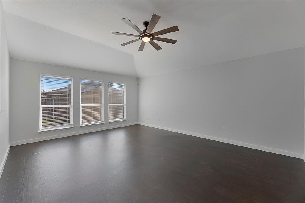 605 Clearbrook Street Azle, TX 76020 - Photo 12 of 33 Spacious room featuring vaulted ceilings and dark wood-finish flooring