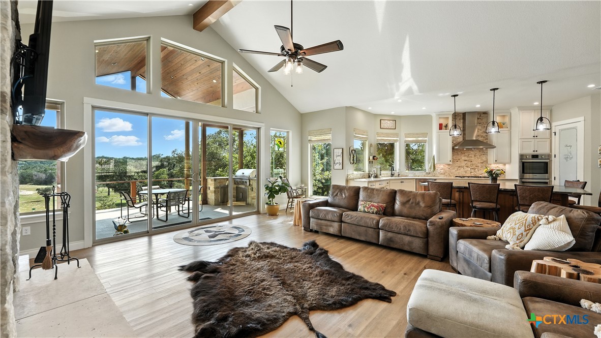 134 Stallion Estates Drive Spring Branch, TX 78070 - Photo 17 of 48 a living room with furniture ceiling fan and a large window