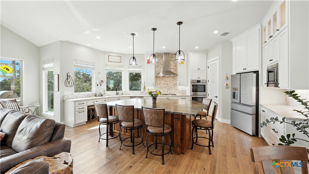 134 Stallion Estates Drive Spring Branch, TX 78070 - Photo 24 of 48 a view of a dining room with furniture window and wooden floor