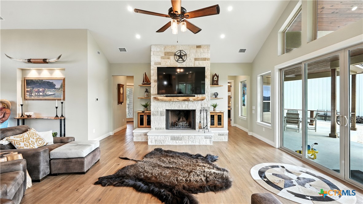 134 Stallion Estates Drive Spring Branch, TX 78070 - Photo 26 of 48 a living room with furniture a flat screen tv and a fireplace