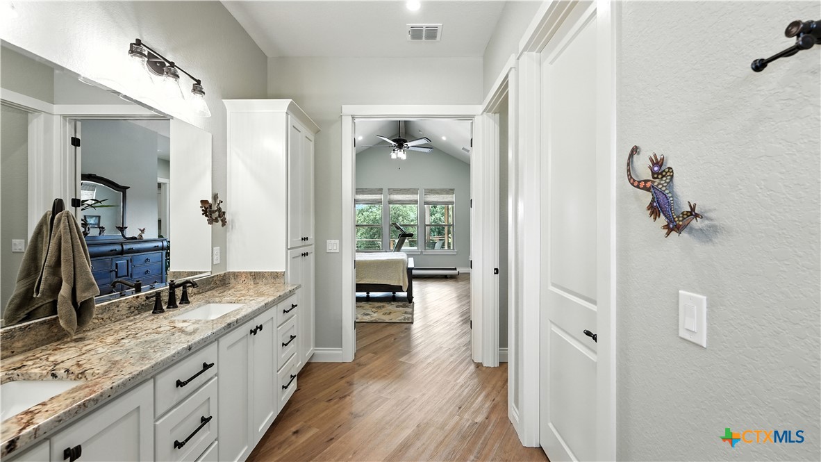 134 Stallion Estates Drive Spring Branch, TX 78070 - Photo 30 of 48 a spacious bathroom with a granite countertop sink mirror and a bath tub