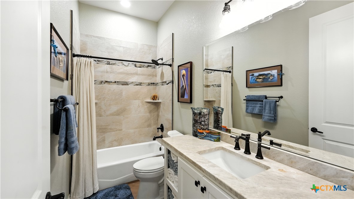 134 Stallion Estates Drive Spring Branch, TX 78070 - Photo 38 of 48 a bathroom with a granite countertop sink toilet and shower