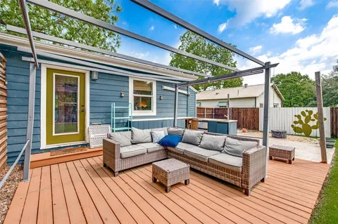 a balcony with furniture and wooden floor