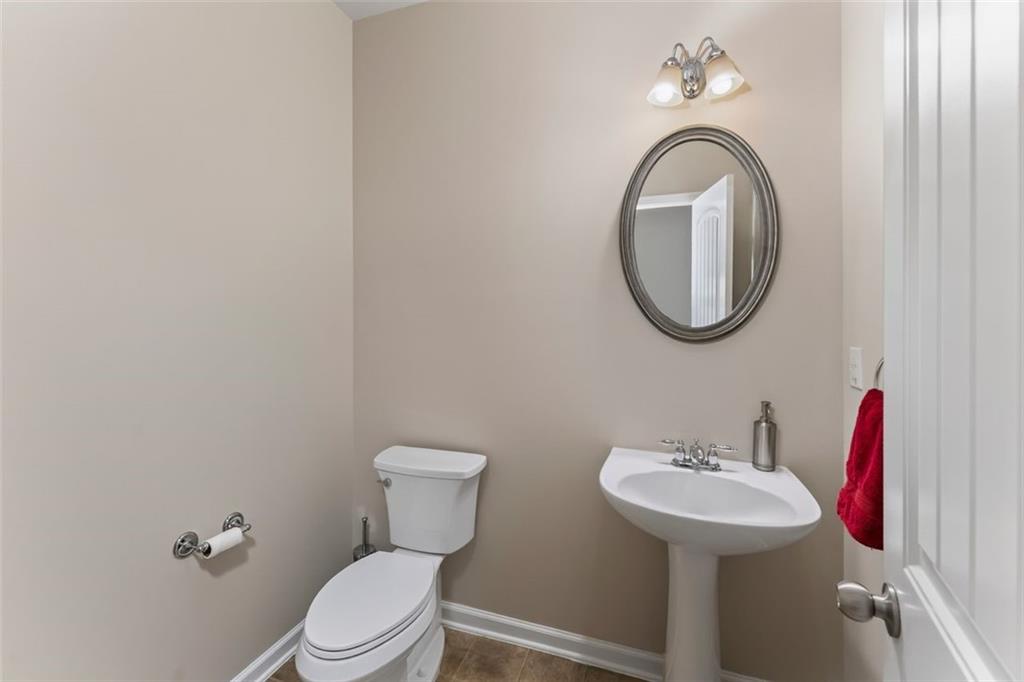 113 Tyson Woods Road Acworth, GA 30102 - Photo 26 of 37 a bathroom with a toilet sink and mirror