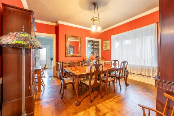 a view of a dining room with furniture window and wooden floor