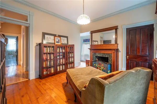 a bedroom with a large bed and a fireplace