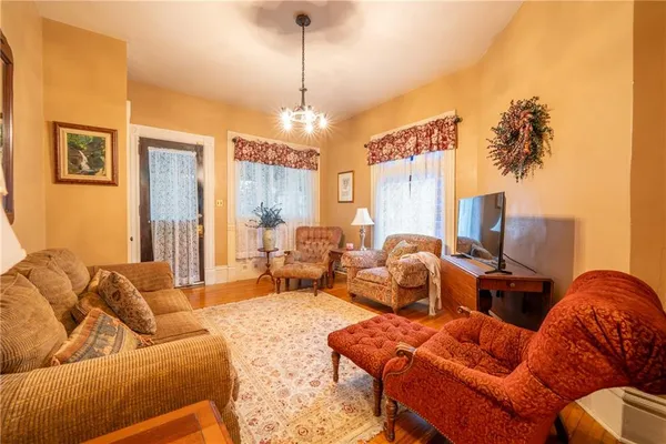 a living room with furniture and a chandelier