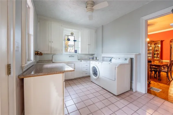 a utility room with cabinets washer and dryer