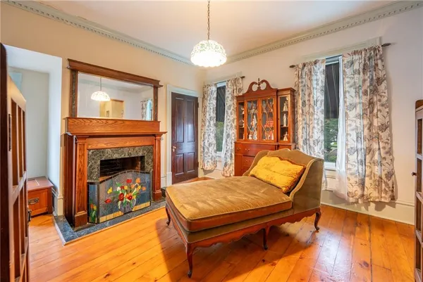 a living room with furniture a table and a fireplace