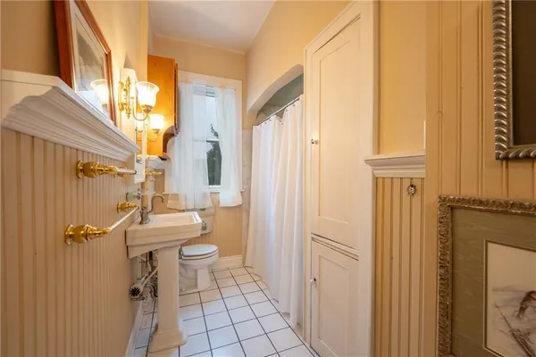 a bathroom with a toilet a sink and a mirror
