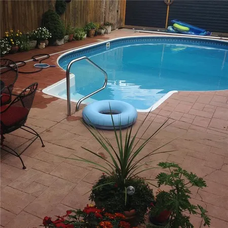 a roof deck with table and chairs potted plants and wooden fence