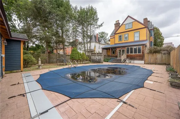 a patio with a table and chairs under an umbrella