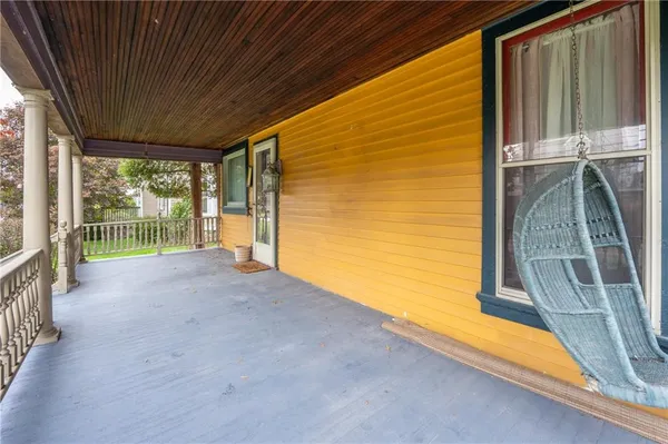 a view of a porch with wooden floor and fence