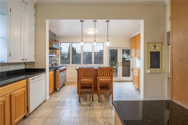 a kitchen with granite countertop a table and chairs