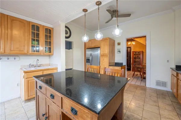 a kitchen with stainless steel appliances granite countertop a sink a oven and a dining table