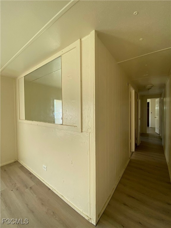 8376 Nault Road North Fort Myers, FL 33917 - Photo 6 of 10 a view of a hallway with wooden floor