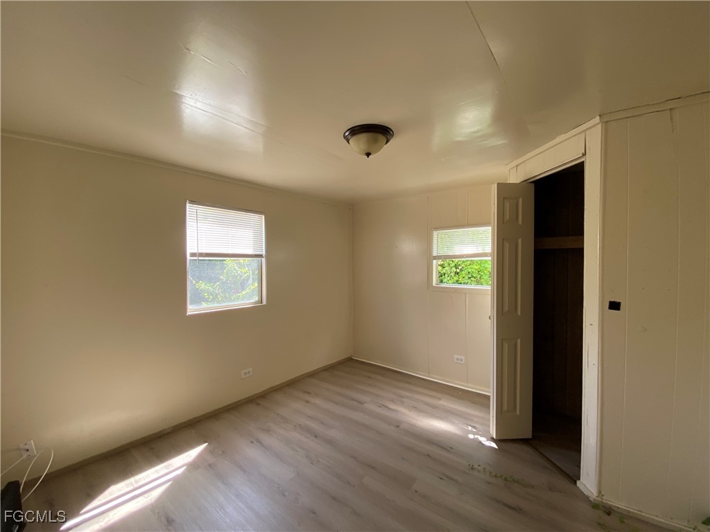 8376 Nault Road North Fort Myers, FL 33917 - Photo 10 of 10 a view of an empty room with wooden floor and a window